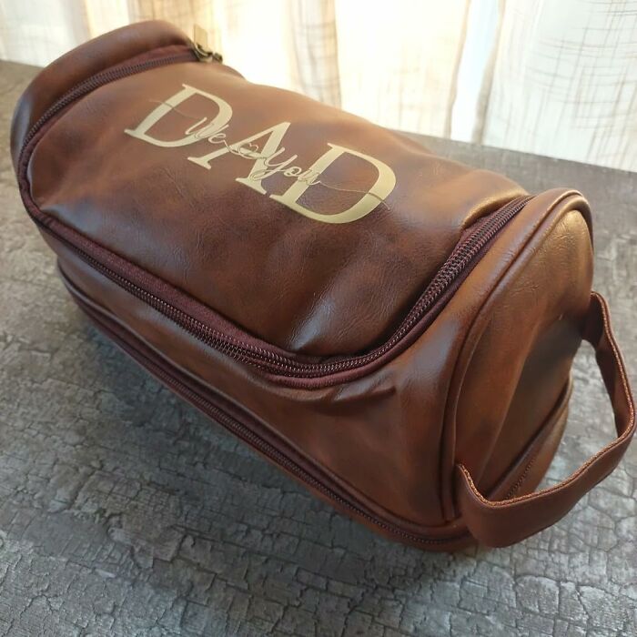 Brown leather custom gift bag with "Dad" text, a personalized present ready in time for Christmas.