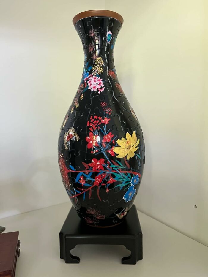 Black floral vase puzzle gift on a black stand, perfect for unique white elephant gift ideas.