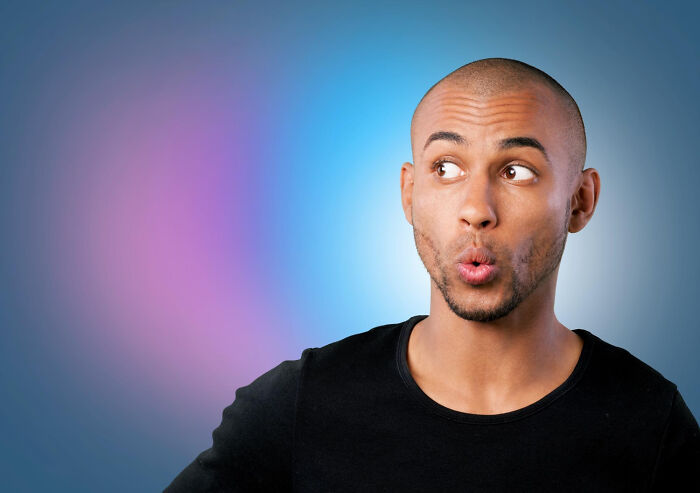 Man with surprised expression looking to the side against colorful background illustrating everyday things done wrong concept