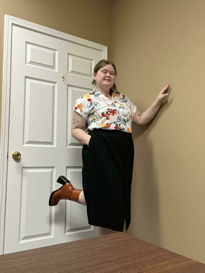 Person seemingly floating sideways against a beige wall, creating a confusing photo that challenges brain perception.