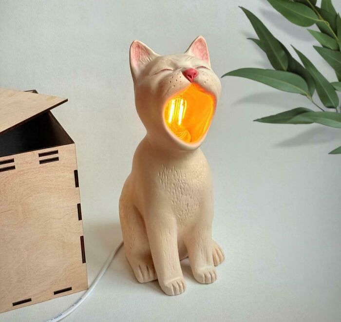 Unique and cool cat lamp design glowing warmly, showcasing something people made to share with everyone.