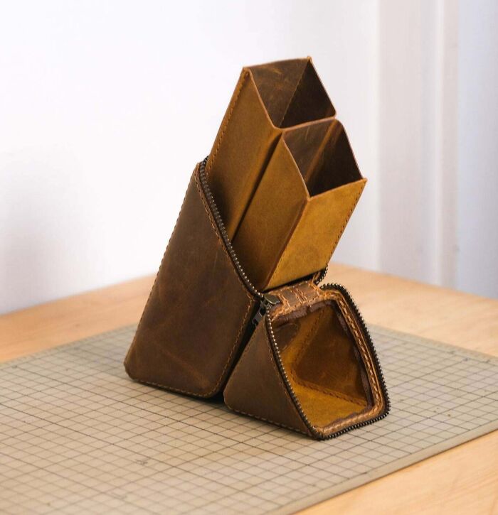 Handcrafted leather pouch with multiple compartments, showcasing cool and creative design shared by people.