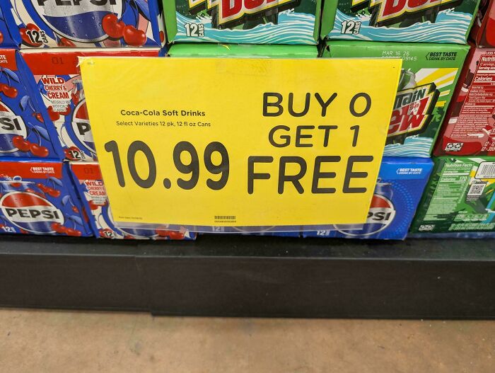 Sign showing a poor job with pricing that reads buy zero get one free on Coca-Cola soft drinks.