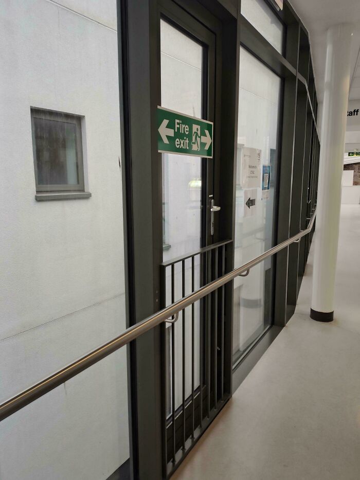 Fire exit sign placed on a window that cannot be used as an exit, illustrating poor job e*******n.