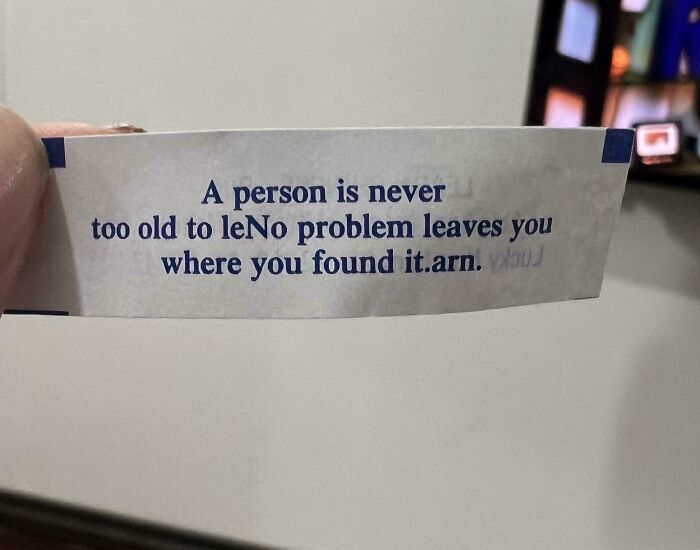 Fortune cookie slip with poorly printed and mixed-up text, illustrating job mistakes that are almost impressive.