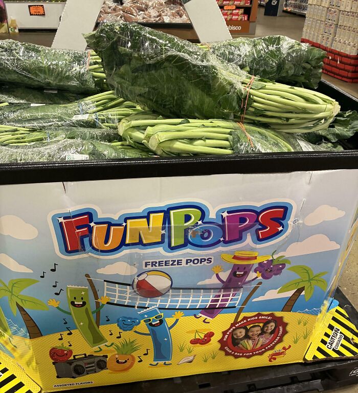 Produce display mislabeled with leafy greens instead of freeze pops, showing a job done so poorly it’s almost impressive.