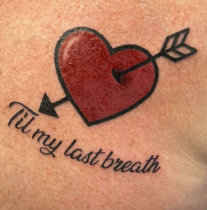 Red heart pierced by an arrow tattoo with the phrase til my last breath, showcasing wholesome tattoos with meaningful ink. Red heart pierced by an arrow tattoo with the phrase til my last breath, showcasing wholesome tattoos with meaningful ink.