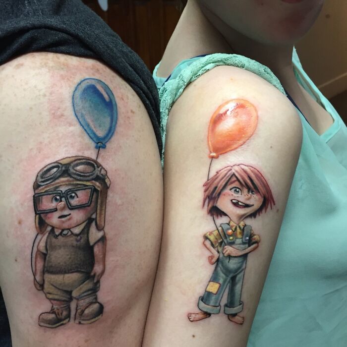 Matching wholesome tattoos of animated children holding colorful balloons on upper arms, showcasing meaningful ink designs.