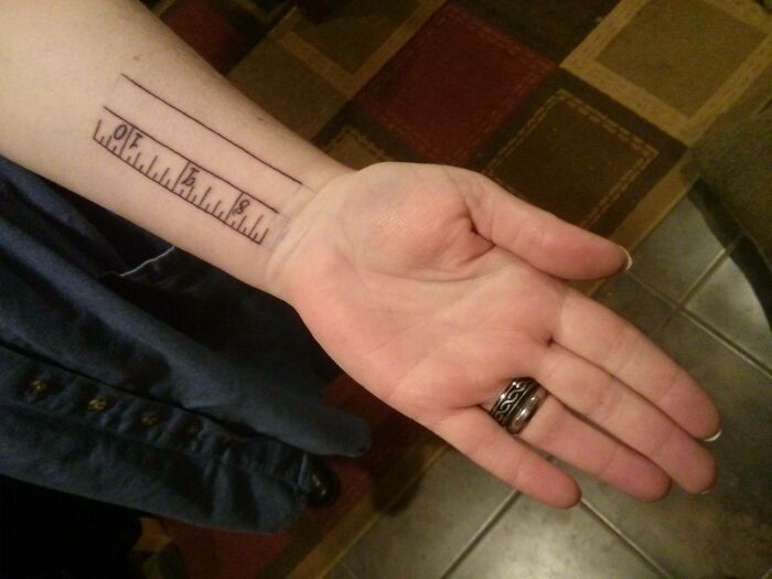 Forearm tattoo of a simple ruler design, showcasing wholesome tattoos with meaningful and minimalistic ink.