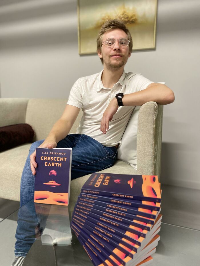 Young man holding a book surrounded by multiple copies, symbolizing leap of faith and best life decisions themes.