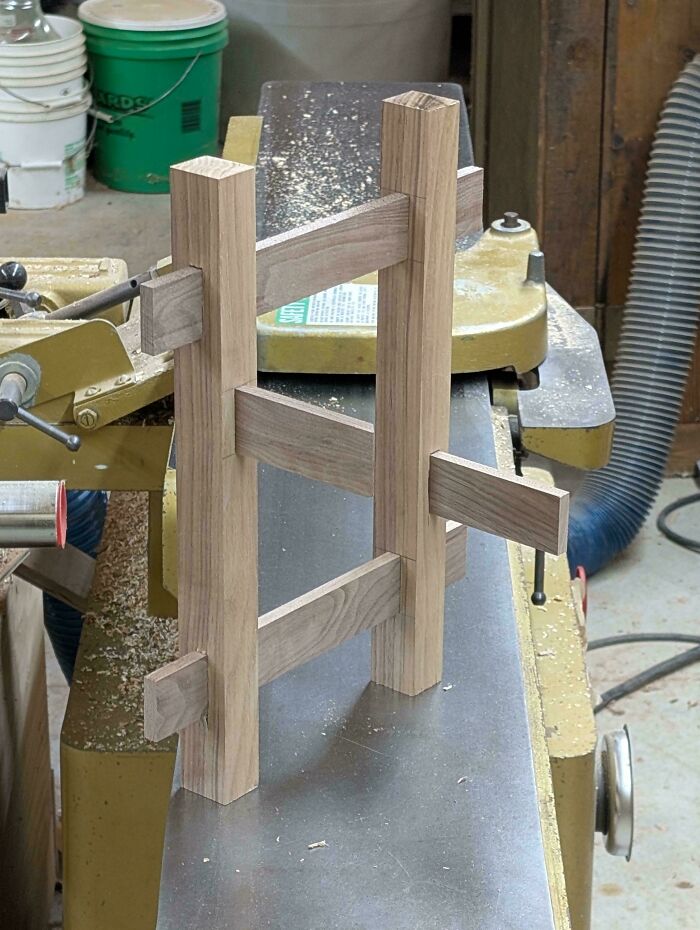 Woodworking project with wooden pieces connected in an impossible configuration, a photo so confusing your brain might need a moment.