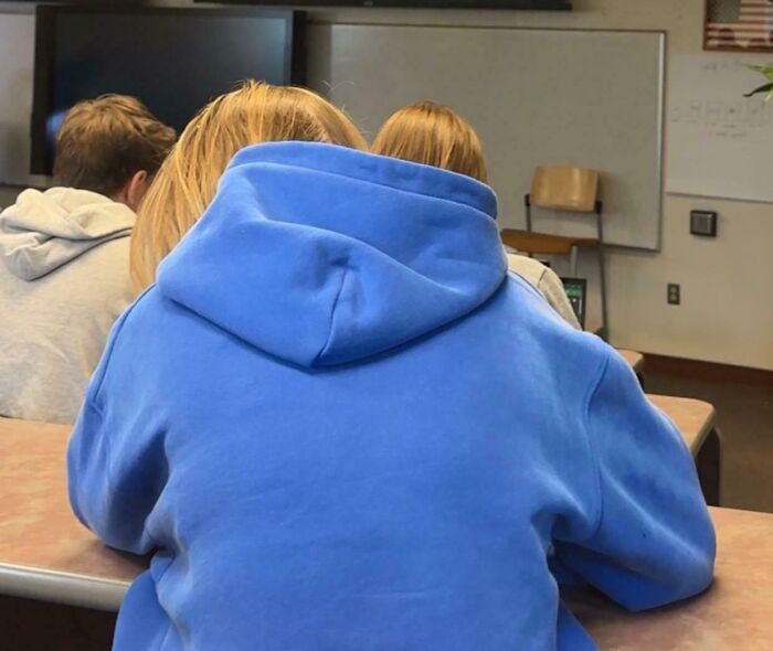 Student wearing a blue hoodie in a classroom setting, creating a confusing visual that tricks the brain.