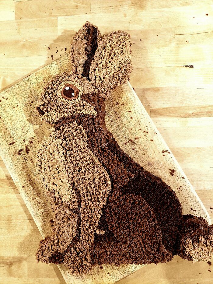 Rabbit-shaped cake with detailed chocolate frosting showcasing masterfully crafted cakes and human creativity.