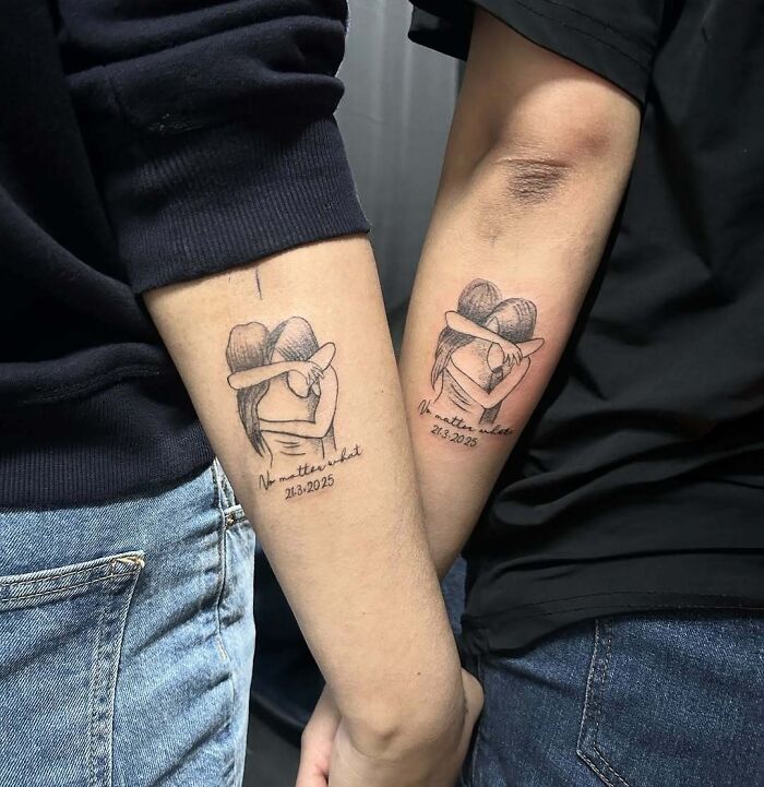 Matching wholesome tattoos of two people hugging with the phrase no matter what and a date on forearms. Matching wholesome tattoos of two people hugging with the phrase no matter what and a date on forearms.