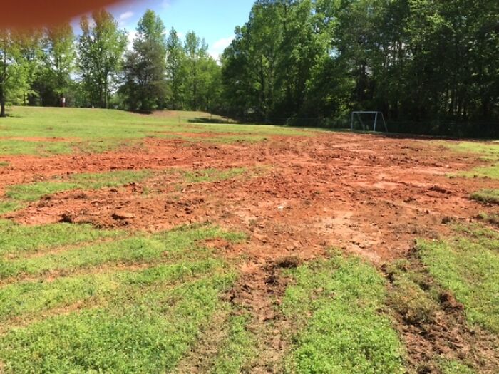 Partially destroyed grass field with muddy tire tracks, illustrating one of the rage-inducing pics challenging calmness.