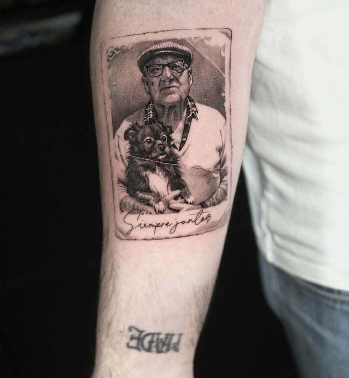 Realistic wholesome tattoo of an elderly man holding a dog with heartfelt details on a forearm.