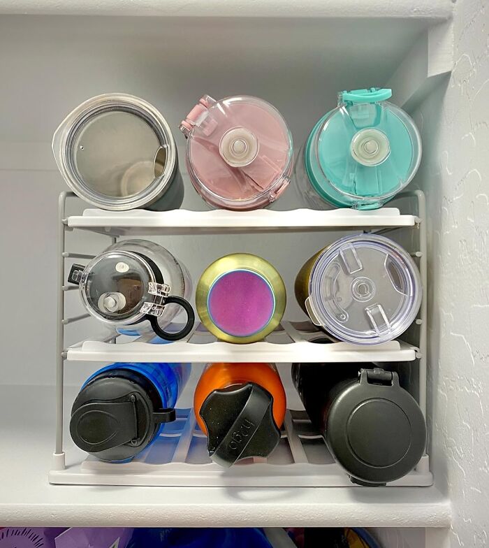 The Precarious, Jenga-Like Tower Of Emotional Support Water Bottles That Threatens To Avalanche Out Of Your Cabinet Every Time You Open It Can Now Be Beautifully Wrangled By A Water Bottle Organizer 