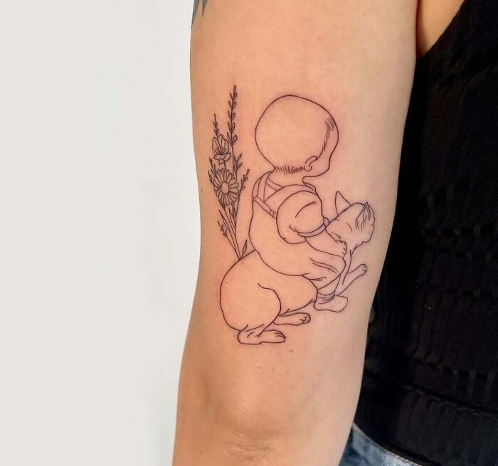 Minimalist wholesome tattoo of a child hugging a bunny with flowers, showcasing meaningful ink on an arm.