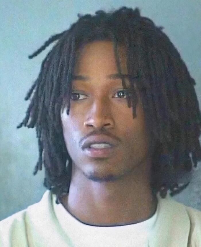 Young man with dreadlocks in a close-up mugshot representing infamous celebrity mugshots and arrest reasons.