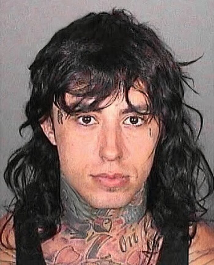 Mugshot of a young male celebrity with long black hair and tattoos, part of infamous celebrity mugshots collection.