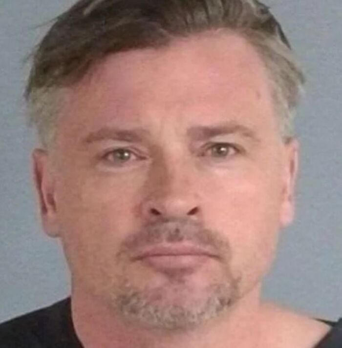 Mugshot of a man with short hair and facial hair, part of infamous celebrity mugshots collection.