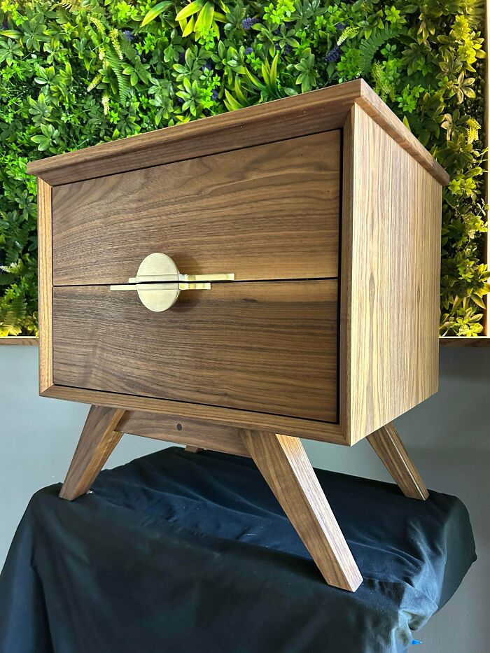 Modern wooden nightstand with brass handle carved by woodworkers, showcasing incredible woodworking craftsmanship and design.