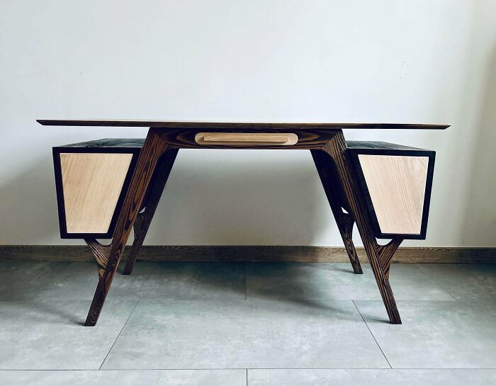 Modern wooden desk with sleek design and light wood drawer panels showcasing incredible woodworking projects.