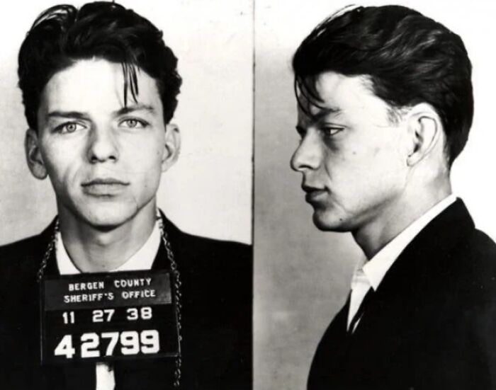 Black and white infamous celebrity mugshot showing front and side profile with inmate number from Bergen County.
