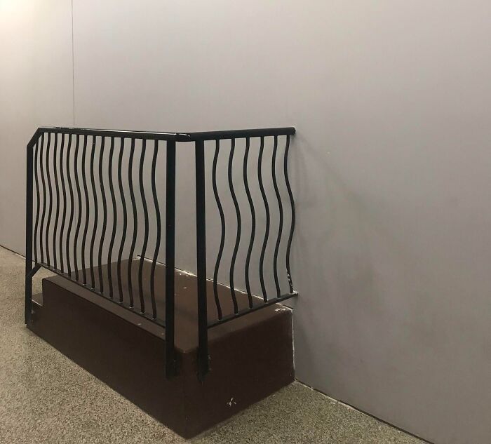 Poorly installed railing that ends abruptly, showcasing a job done so poorly it is almost impressive.