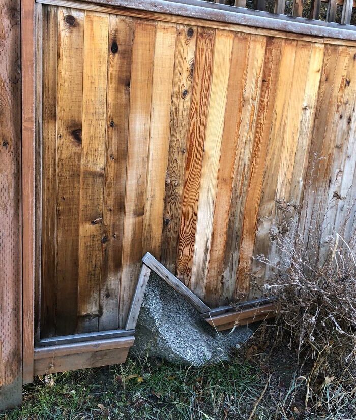 Wooden fence poorly built around a concrete block, showing examples of people doing their jobs poorly.