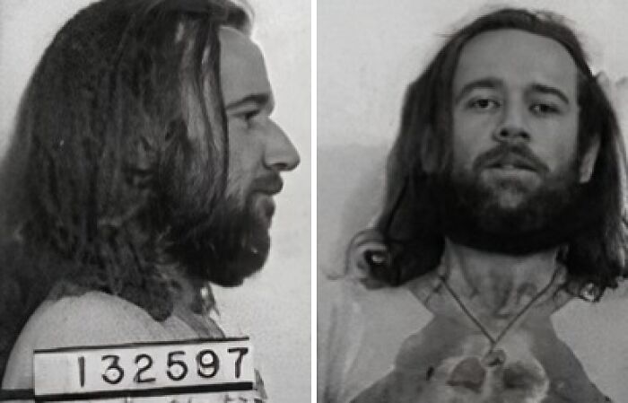 Black and white infamous celebrity mugshot showing front, side, and full-body views with stained shirt and long hair.