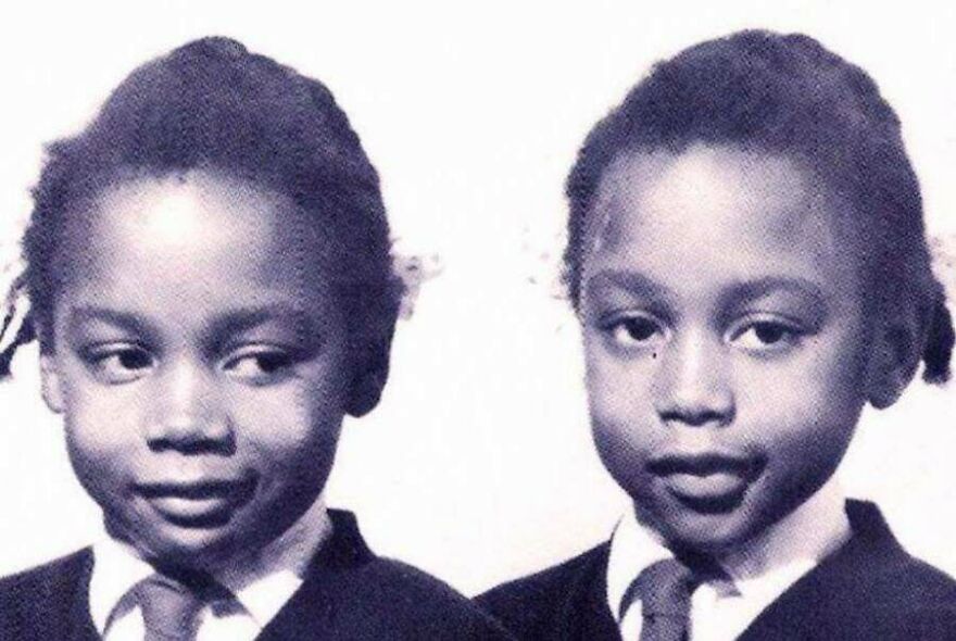 Black and white photo of two young children in school uniforms, a random picture worth going down a rabbit hole for.