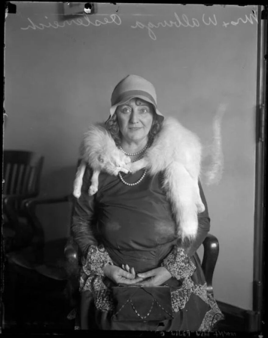 Vintage black and white photo of a woman wearing a fur stole and cloche hat, part of random pictures worth going down a rabbit hole for.