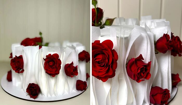 Masterfully crafted white cake decorated with realistic red roses showcasing creativity in cake design.