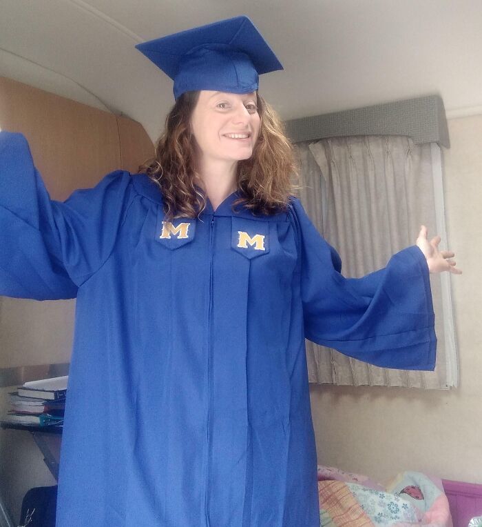 A woman wearing a blue graduation gown and cap smiling, symbolizing a leap of faith and life decisions.