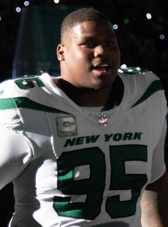 Quinnen Williams in New York Jets uniform during a game, showcasing his career as a professional football player.