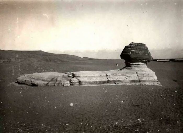 Ancient Egypt photograph showing the Great Sphinx with desert landscape and distant hills under a clear sky.