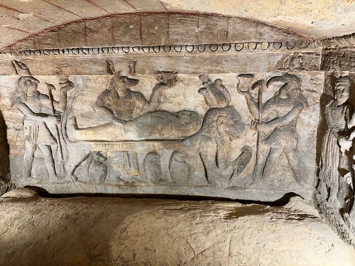 Ancient Egypt stone carving depicting deities and a lion, showcasing incredible historical artwork and cultural symbolism.