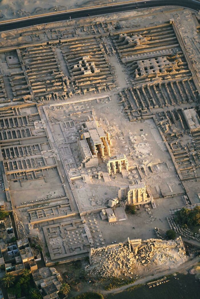 Aerial view of ancient Egypt ruins showcasing detailed archaeological site with columns, walls, and structures from historic times.