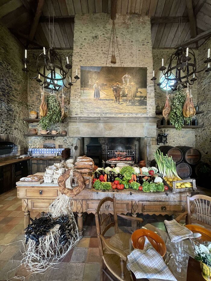 Rustic kitchen with fresh vegetables, bread, and hanging herbs showcasing different jobs that make a 9-to-5 more bearable.