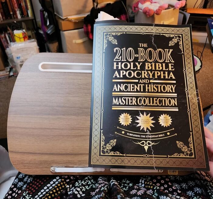 Hardcover 210-Book Holy Bible Apocrypha and Ancient History collection on a wooden lap desk surface.
