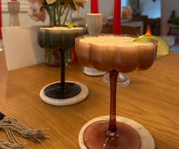 Two stylish cocktails on a wooden table, perfect unique gifts to impress your mother-in-law with cool ideas.