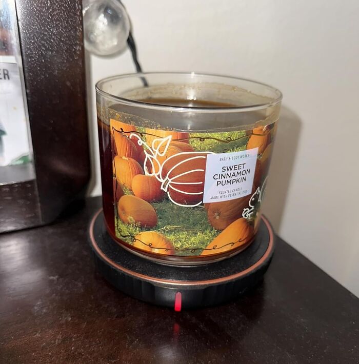 Sweet cinnamon pumpkin scented candle on a table, a cozy gift idea to impress your mother-in-law with unique presents.