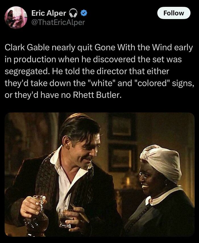 Clark Gable and actress smiling together on Gone With the Wind set, sharing a warm moment in classic film scene.