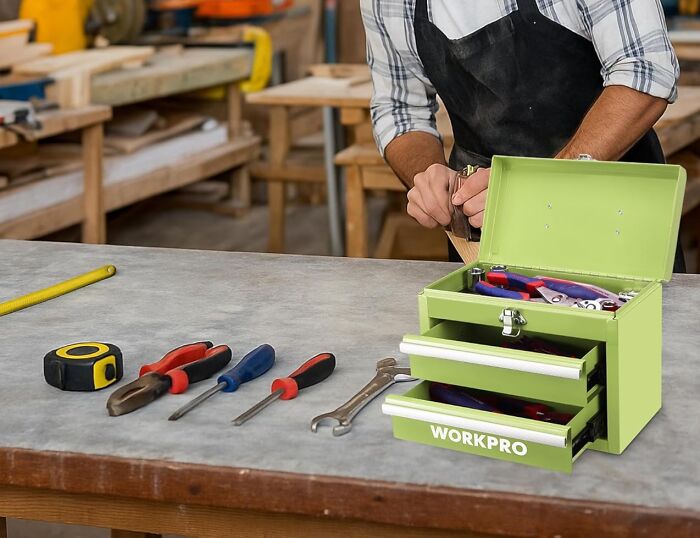 Toolbox and hand tools on workbench with person using hand plane, illustrating gifts found in an isle at Hobby Lobby. Toolbox and hand tools on workbench with person using hand plane, illustrating gifts found in an isle at Hobby Lobby.