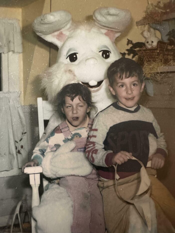 Vintage awkward childhood photo of two kids sitting with a person in a large bunny costume, capturing hilariously awkward moments.