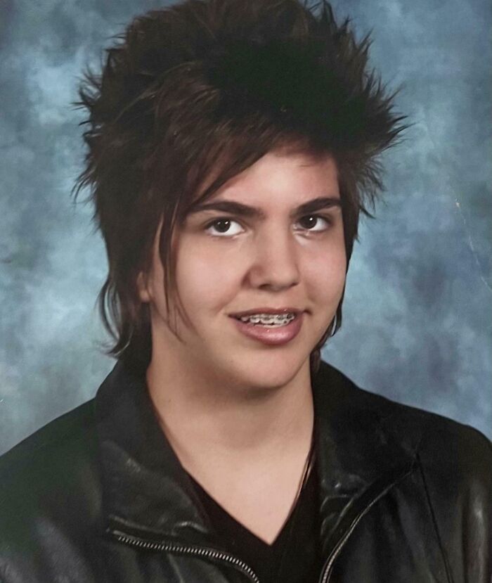 Teen boy with braces and spiky hair wearing a leather jacket, a hilarious awkward childhood photo from the collection.
