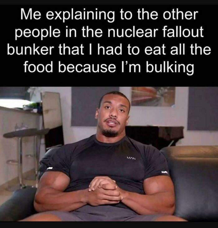 Muscular man sitting on a couch explaining a funny gym meme about bulking and eating all the food in a nuclear fallout bunker.