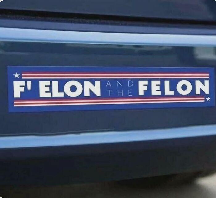 Sticker on a car bumper with a clever designer phrase showcasing smart and cool design creativity.