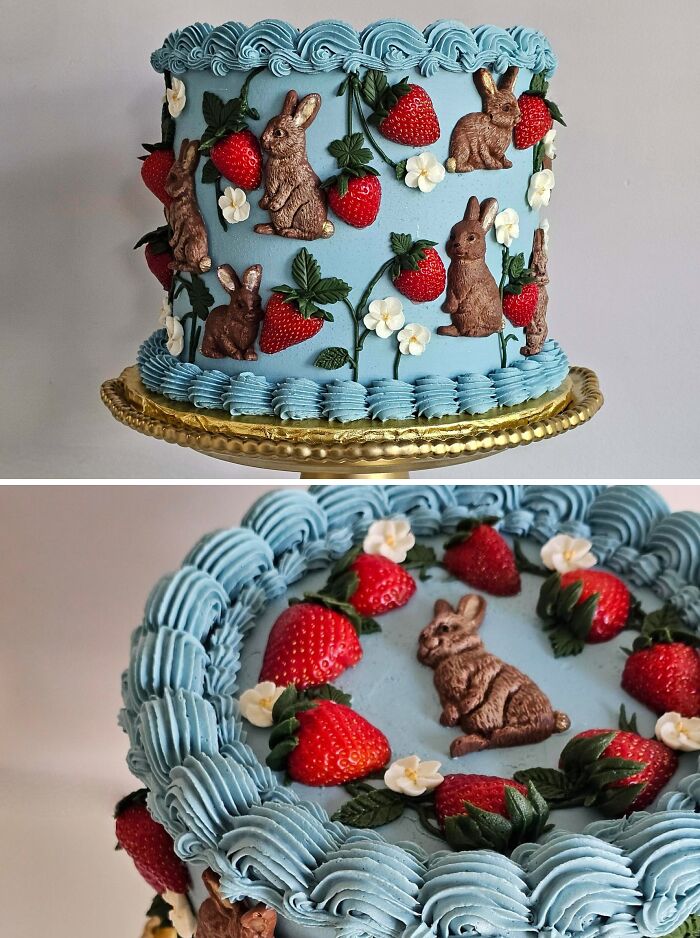 Blue cake decorated with intricate rabbit designs, strawberries, and white flowers showing masterfully crafted cake creativity.